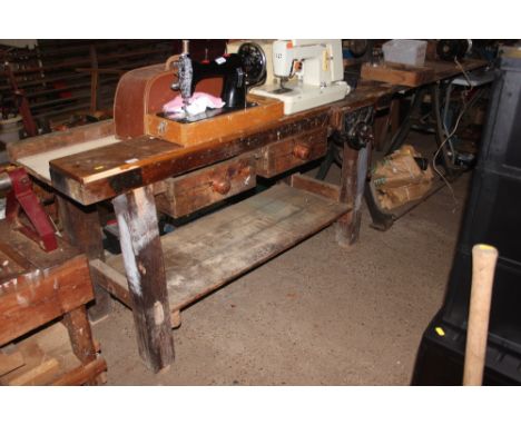 A wooden work bench with vice attached