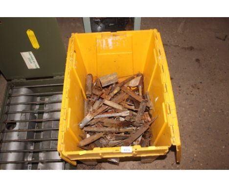 A plastic crate of various hand tools