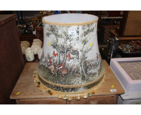 A large lampshade decorated with hunting scenes