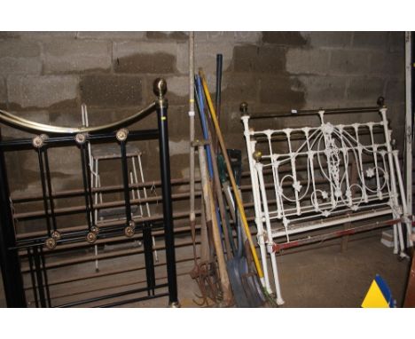 A bundle of long handled gardening tools