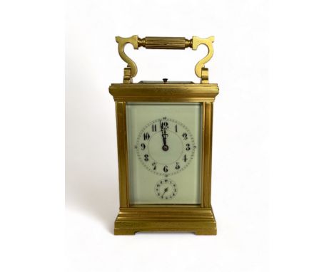 A French quarter-striking brass carriage clock
With enamelled dial with Arabic numerals and subsidiary seconds dial,19cm high