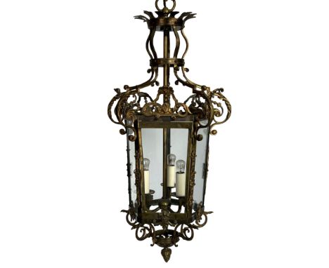 A 20th century Louis XV style gilt bronze three-light hexagonal hall lantern
With glazed sides and applied with pierced scrol