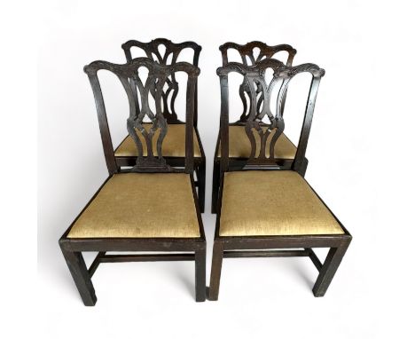 A set of four George III provincial carved mahogany dining chairs in the Chippendale style
The pierced arched gothic backs an