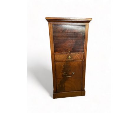 A late George III mahogany pot cupboard
With a tambour door above a small drawer and converted commode drawers, on a plinth b