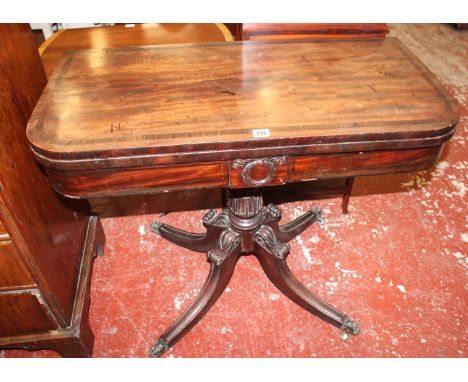 A late Regency mahogany folding card table, circa 1820, the rectangular rosewood banded top with rounded corners opening to b