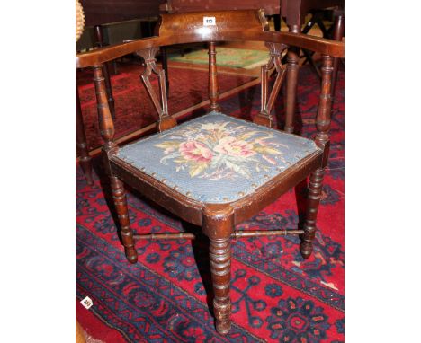 An Edwardian mahogany corner chair with tapestry drop in seat