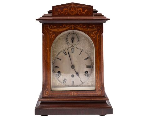 An Edwardian mahogany chiming German mantel clock the eight-day duration movement striking the hours and quarters on four gon