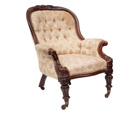 A gentleman's Victorian carved mahogany armchair; the curved upholstered button down back with cabochon, cartouche and foliat
