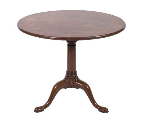 A 19th Century mahogany circular tea table in the George II taste, with a snap top on a turned column, headed with a bird cag