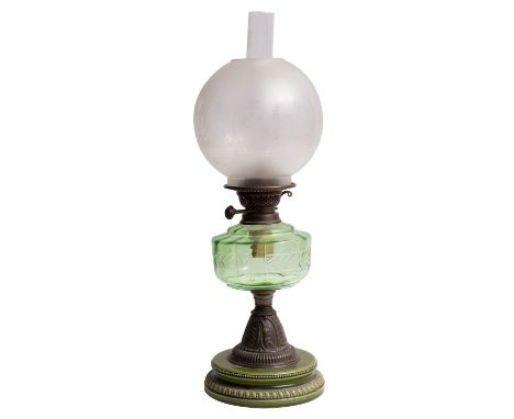 A Victorian ceramic, glass and metal mounted table oil lamp, late 19th Century; the flue and etched spherical shade above a b