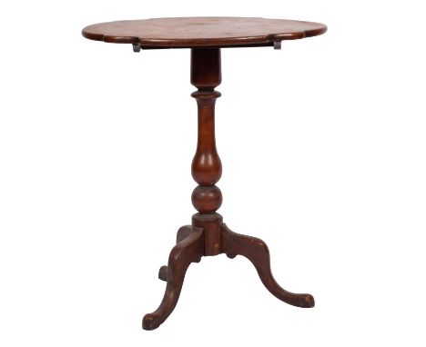 A Victorian mahogany tripod table, mid 19th century; the shaped oval top,  baluster stem, set on three cabriole legs with pad