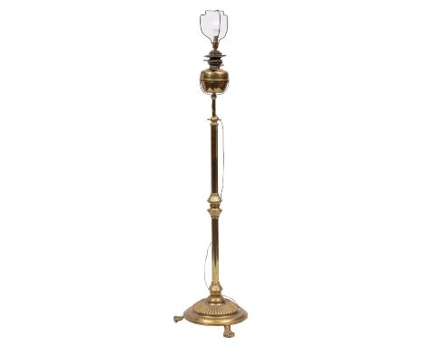 A Victorian brass telescopic standard oil lamp, adapted for electricity; with circular front on turned and reeded adjustable 
