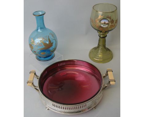 A cranberry glass dish, of circular form loose mounted in a Holmes and Edwards silver plated frame, with chased and pierced b