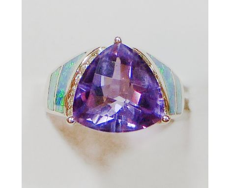 A 14 k gold, amethyst, diamond and opal doublet dress ring, claw set with a triangular cut stone flanked by brilliants and do