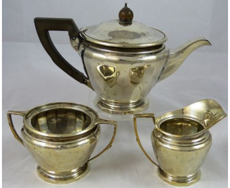 A silver three piece tea service, Birmingham 1919, of circular panelled form, comprising; tea pot, sugar bowl and milk jug, e