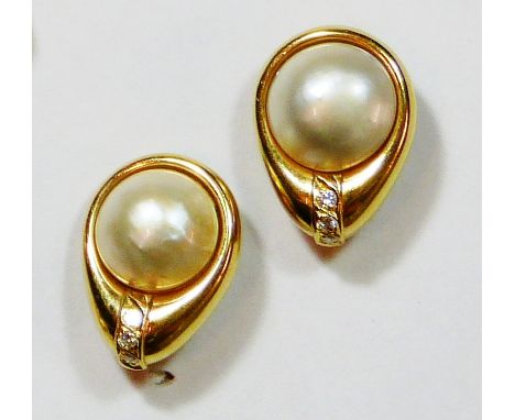 A pair of gold, Mabe pearl and diamond ear clips, set with three brilliant cut stones beneath the pearl, weight 12 grams.
