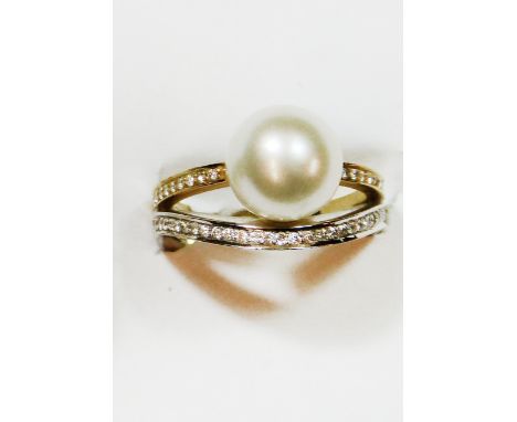 An 18ct white and yellow gold, cultured pearl and diamond dress ring, set with a 10 mm pearl to brilliant cut diamond shoulde