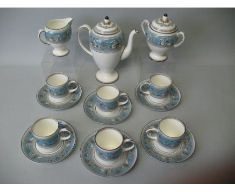 A Wedgwood coffee service, in the 'Florentine' pattern comprising coffee pot and cover, six cans and saucers, sucrier and cov