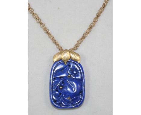 A carved lapis lazuli pendant, in the form of fruit, to a 9ct gold fancy link chain, weight of chain 25 grams.