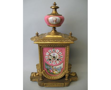 A 19th century French porcelain and gilt mantel clock circa 1870, the pink enamel dial with Roman numerals and a pastoral sce