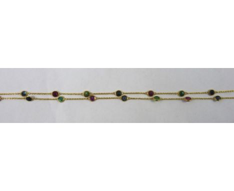 A 14ct gold, ruby, sapphire and emerald chain, spectacle set with mixed cut stones, length 67 cm, weight 5.5 grams.