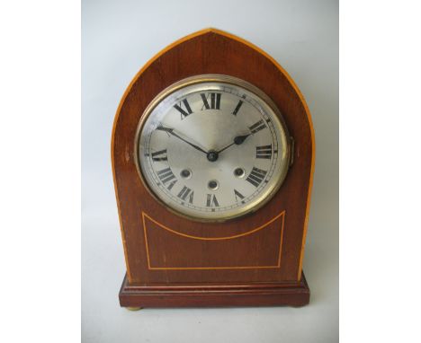 An Edwardian mahogany mantel clock, the silver dial with black Roman numerals, the musical movement numbered 41588, 24 striki