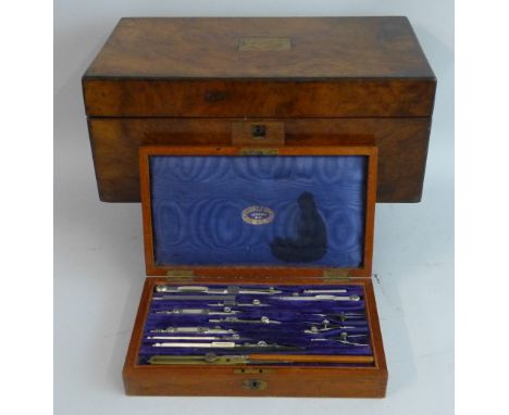 A Victorian walnut writing box, of oblong form, the hinged lid opening to reveal a fitted interior with inset writing surface