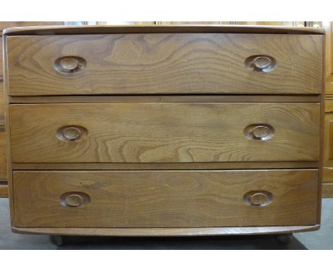 An Ercol elm chest of three drawers