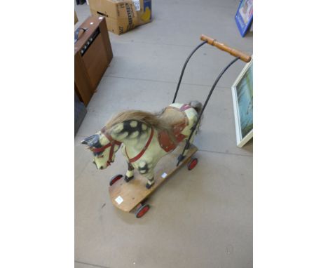 A vintage child's toy pull along horse