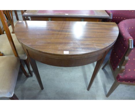 A mahogany demi-lune fold over card table