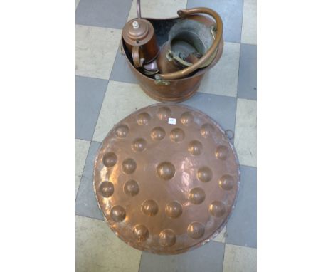 A large embossed copper charger, coal bucket, tea caddy, kettle, bucket, etc.
