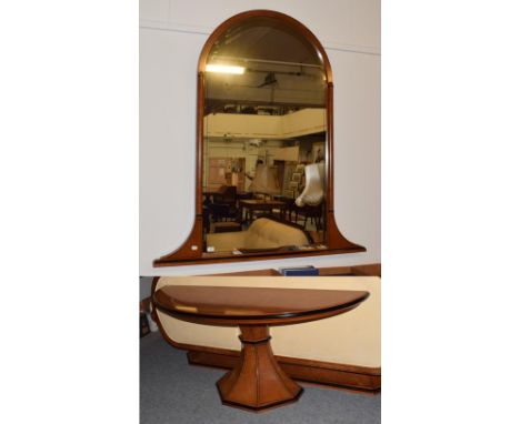 A 20th century Italian design part ebonised walnut console table on faceted pedestal, and a matching mirror, with arched top 