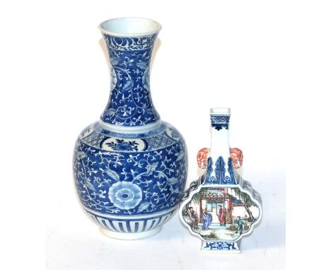 A Chinese blue and white bottle vase, floral design; together with a Chinese famille verte bottle vase, elephant mask handles