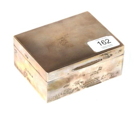 An Elizabeth II silver cigarette-box, Birmingham, 1956, oblong and wood lined, the hinged cover engine turned, 11.5cm wide