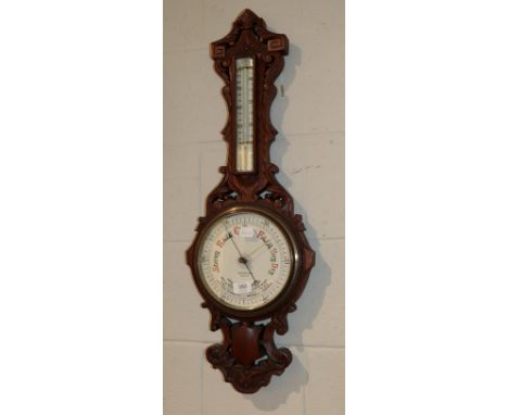 A late Victorian carved oak aneroid barometer, pottery dial signed Geo F. Brown &amp; Co., Carlisle 