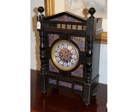 An Aesthetic movement striking ebonised mantel clock, case depicting recessed transfer printed and gilt decorated floral pott