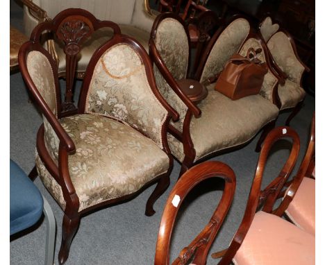 A three piece mahogany framed salon suite comprising a sofa and two chairs