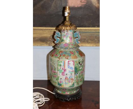 A Canton famille rose twin-handled vase, decorated with vignettes of figures in landscapes, converted to a lamp, 56cm high (i