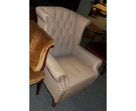 A George III style button-back wingback armchair with studded decoration 