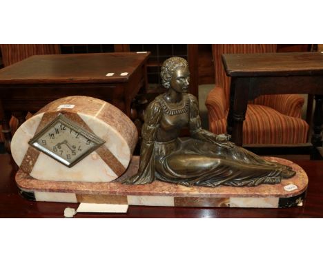 An Art Deco pink marble striking mantle clock with figure of a seated lady 