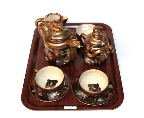 A Japanese Satsuma teaset, Meiji period (1868-1912) bearing mark for Meizan Hododa, comprising: teapot and lid, sucrier and l