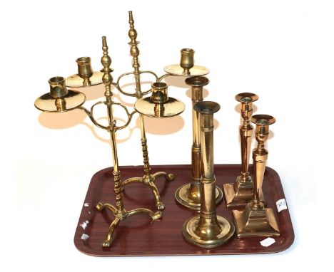 A pair of adjustable twin-light brass candelabra; together with two pairs of brass candlesticks 