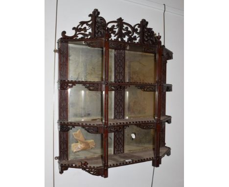 A mirrored mahogany display shelf