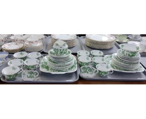 Two trays of Coalport green dragon design tea and dinnerware to include: teacups and saucers, sugar bowl, plates, milk jug, s