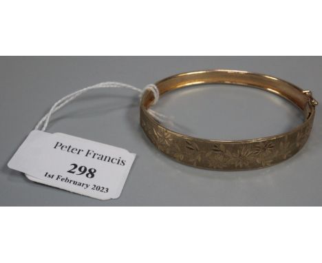 9ct gold engraved bangle.  9.4g approx.  (B.P. 21% + VAT) 
