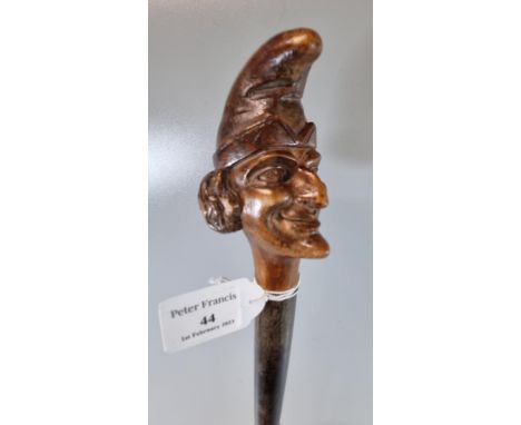 Vintage probably 19th century Mr Punch type carved wooden stick doll with turned stem. 44cm long approx. (B.P. 21% + VAT)