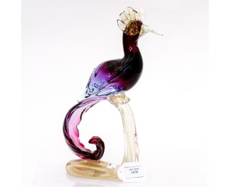 A Murano Bird of Paradise, on glass base, having gold inclusion, the bird being encased, purple glass with clear and gold bea