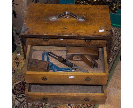 A 19th Century tool chest, oak with three drawers, with brass inset handles, a leather carry handle, tools included in the dr