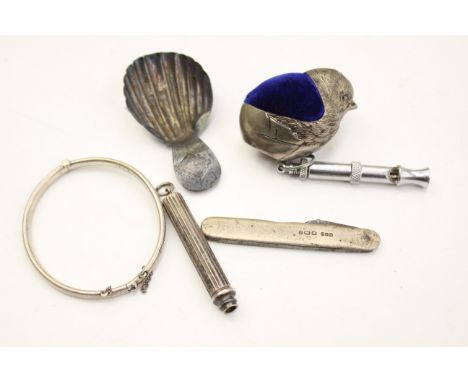 A late Georgian shell shaped caddy spoon a/f marks rubbed, together with a silver plated pin cushion in one form of a chick, 