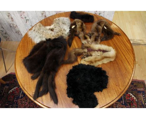 A selection of furs, to include dark brown with tails, and a light spotted cream collar and small black feather boa and doubl